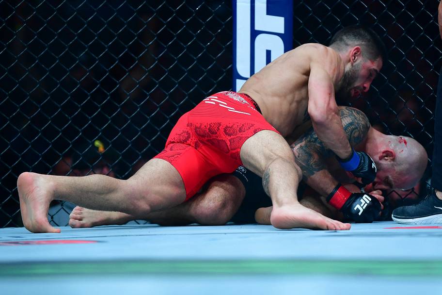 Ilia Topuria lands hits against Alexander Volkanovski for his KO victory during UFC 298 at Honda Center.