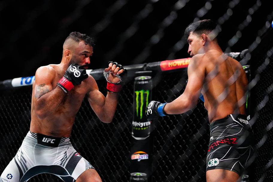Rob Font (red gloves) fights Adrian Yanez (blue gloves) during UFC 287 at Miami-Dade Arena.