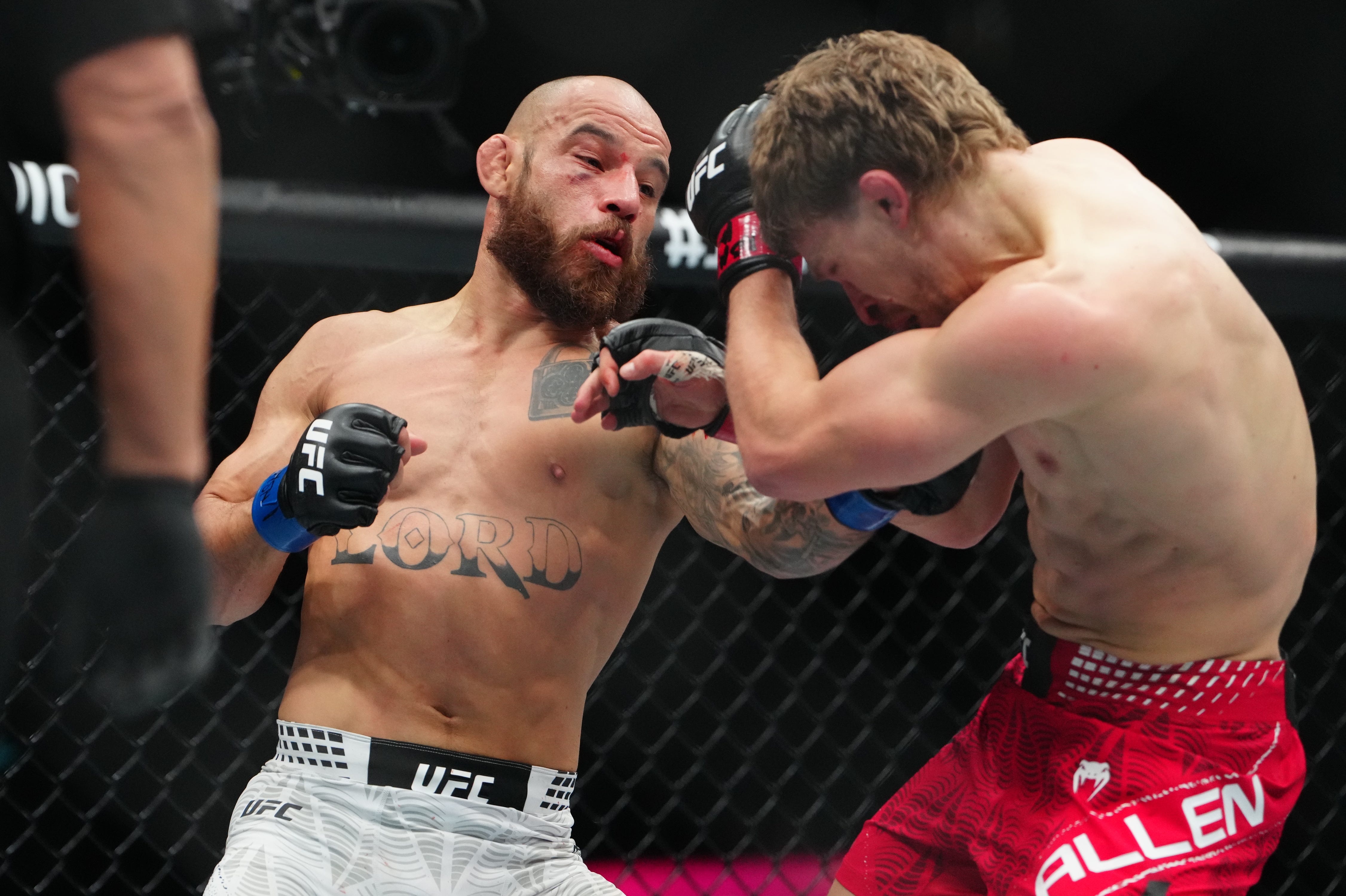 Jan 24, 2026; Las Vegas, Nevada, USA; Arnold Allen (red gloves) fights Jean Silva (blue gloves) during UFC 324 at T-Mobile Arena. Mandatory Credit: Stephen R. Sylvanie-Imagn Images