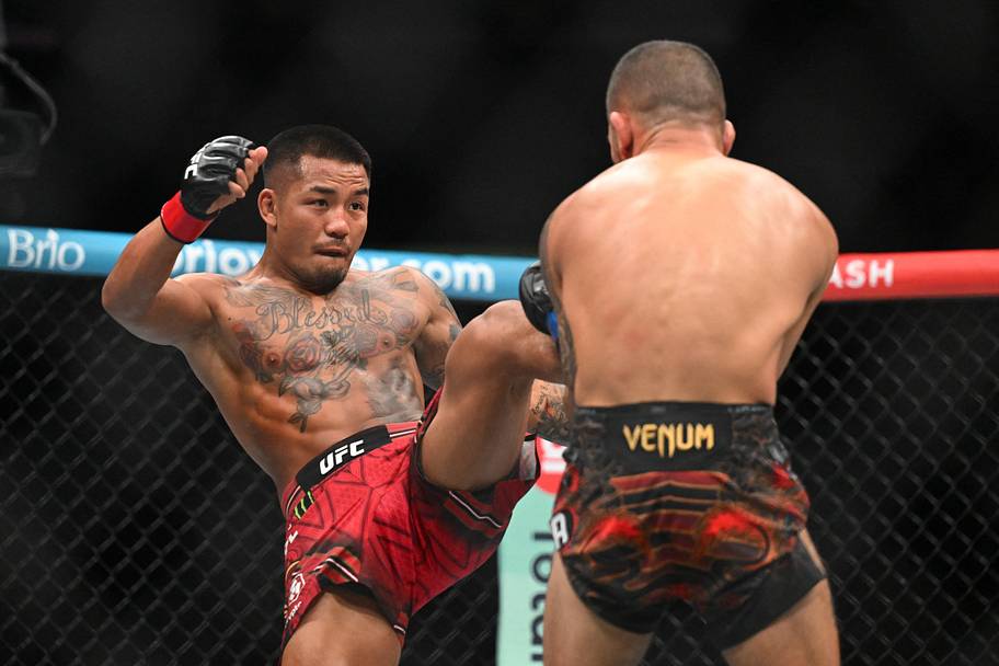 Joshua Van (red gloves) fights Alexandre Pantoja (blue gloves) during UFC 331 at Crypto.com Arena.