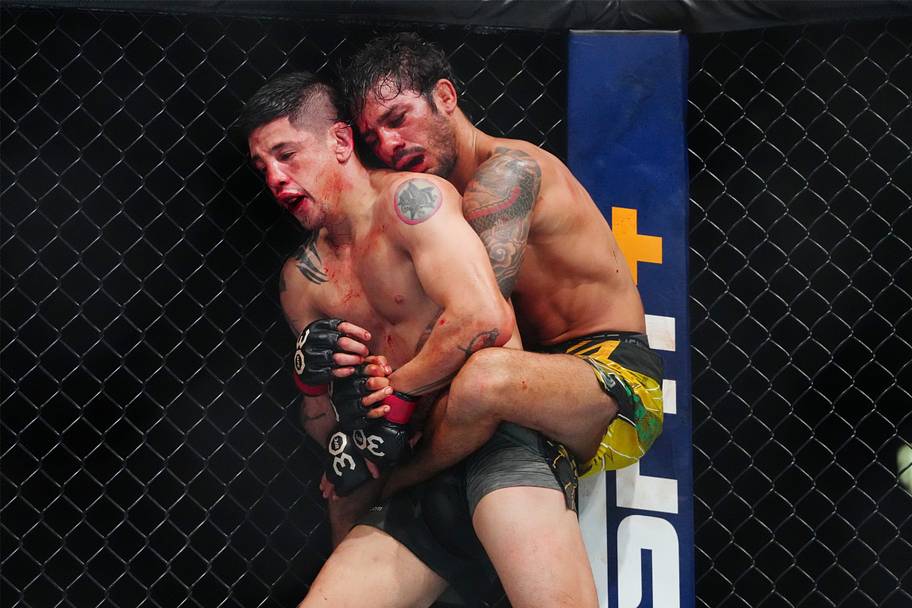 Brandon Moreno (red gloves) fights Alexandre Pantoja (blue gloves) during UFC 290 at T-Mobile Arena.