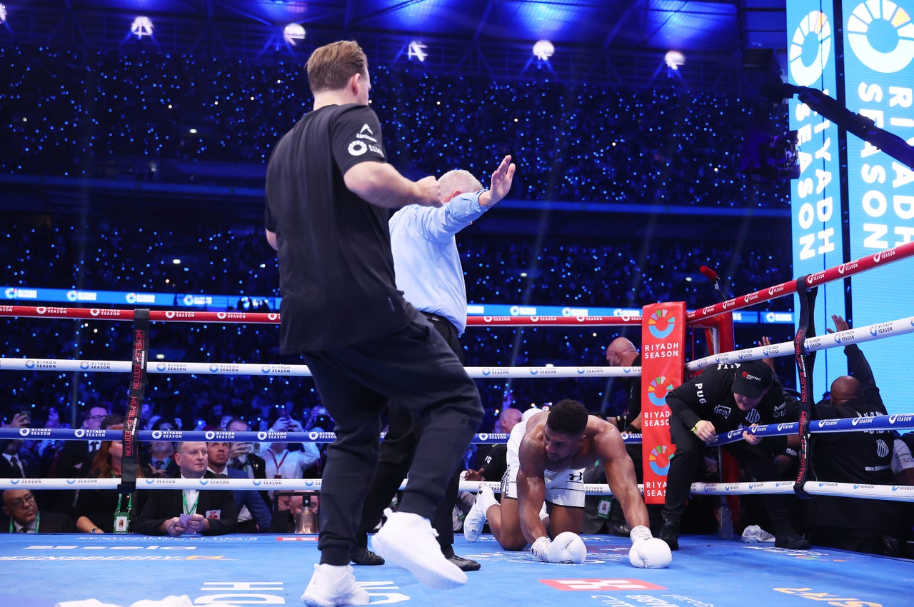 Ben Davison rushes to check on Anthony Joshua after his loss to Dubois (Getty)
