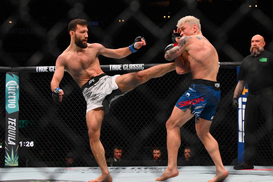 Ricky Simon (red gloves) fights Javid Basharat (blue gloves) in the bantamweight bout during UFC Fight Night at Climate Pledg