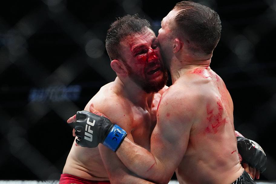 Merab Dvalishvili (red gloves) fights Petr Yan (blue gloves) during UFC 323 at T-Mobile Arena.