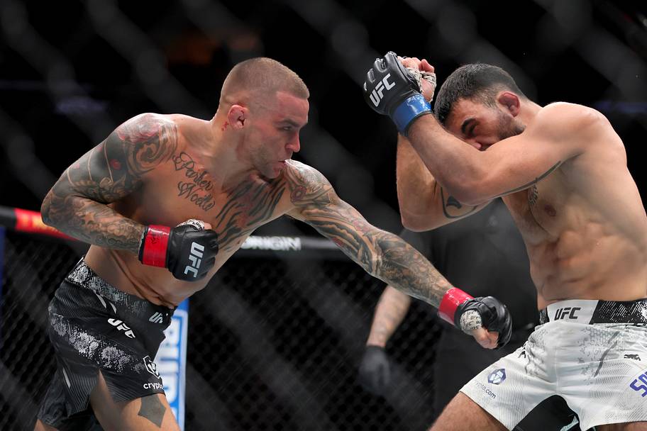 Benoit Saint-Denis (blue gloves) fights Dustin Poirier (red gloves) during UFC 299 at Kaseya Center.