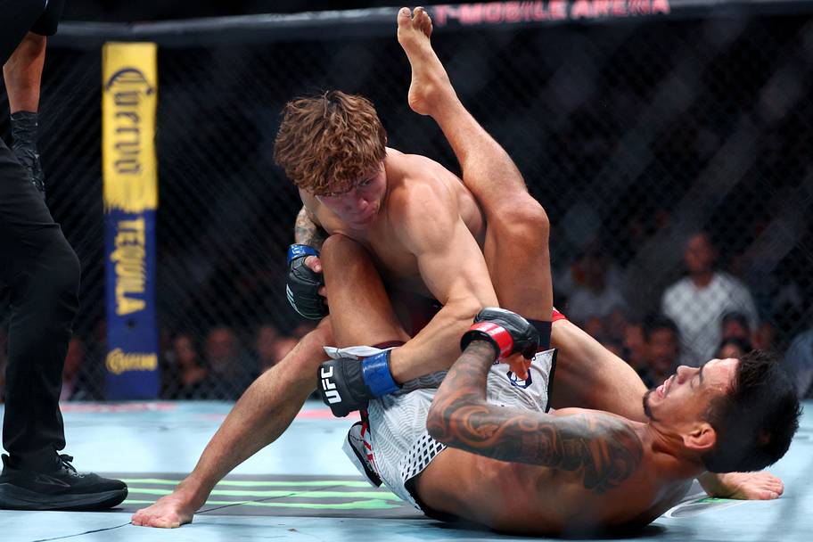 Brandon Royval (red gloves) fights Lone'er Kavanagh (blue gloves) in a flyweight bout during UFC 329 at T-Mobile Arena.