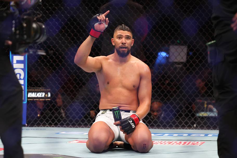 Johnny Walker (red gloves) reacts after the fight against Mick Parkin (blue gloves) during UFC 332 at Delta Center.