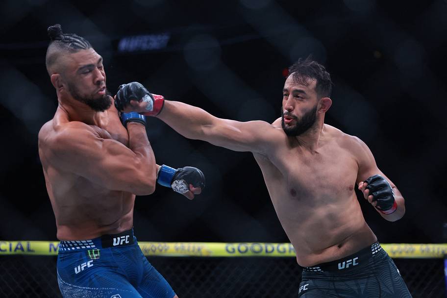 Dominick Reyes (red gloves) fights Johnny Walker (blue gloves) during UFC 327 at Kaseya Center.