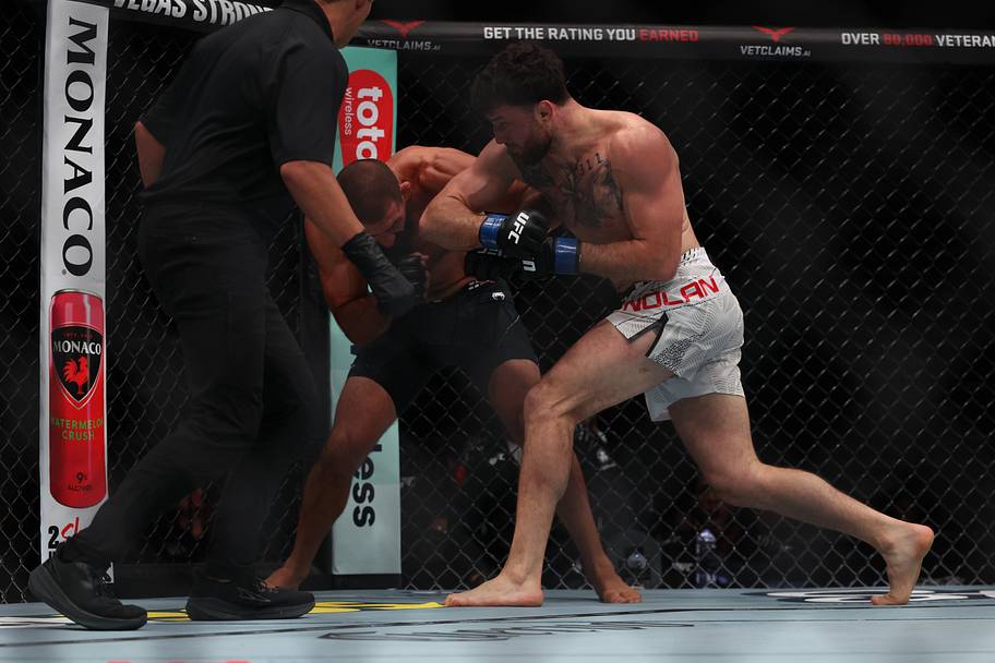 Court McGee (red gloves) fights Eric Nolan (blue gloves) during UFC 332 at Delta Center.
