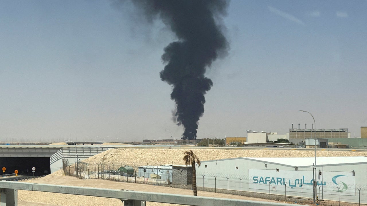 A large plume of black smoke rises from the fuel storage area at King Khalid International Airport (Reuters)