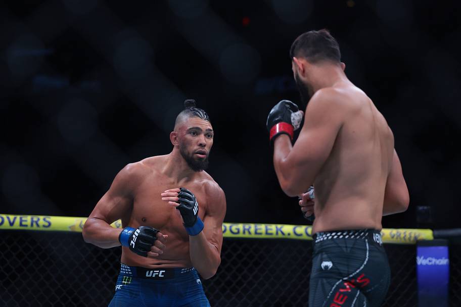 Dominick Reyes (red gloves) fights Johnny Walker (blue gloves) during UFC 327 at Kaseya Center.