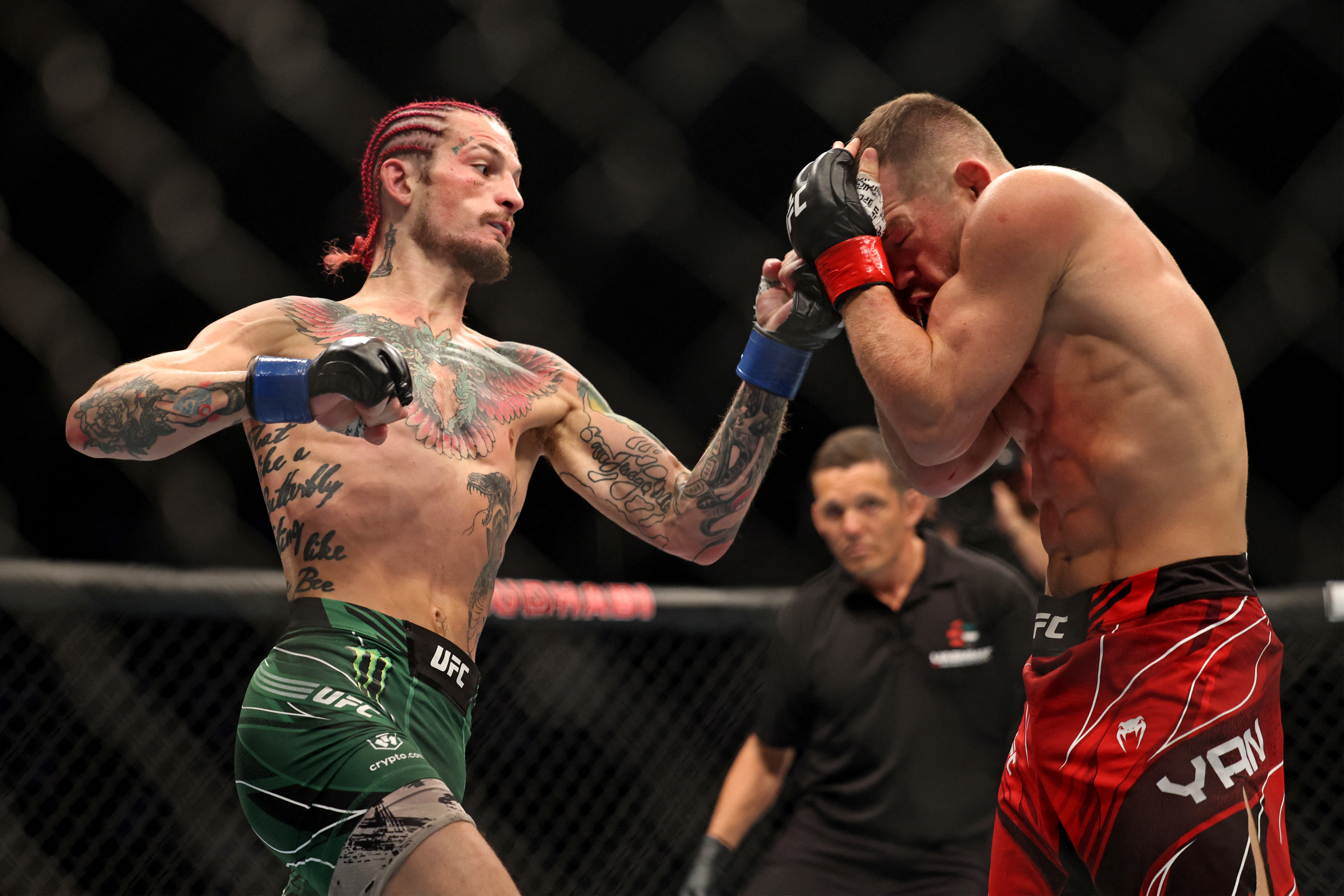 Sean O'Malley (L) competes against Petr Yan in their bantamweight bout at the Ultimate Fighting Championship (UFC) event at the Etihad Arena in Abu Dhabi on October 22, 2022. (Photo by Giuseppe CACACE / AFP via Getty Images)