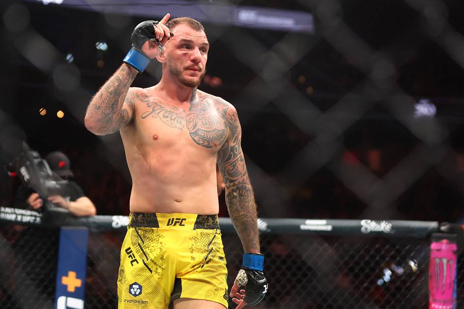 Renato Moicano (blue gloves) reacts after defeating Jalin Turner (not pictured) during UFC 300 at T-Mobile Arena.