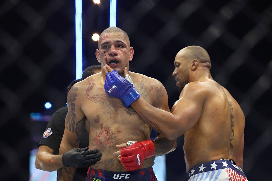 Ciryl Gane (blue gloves) checks on Alex Pereira (red gloves) after their fight during the UFC Freedom 250 at the White House