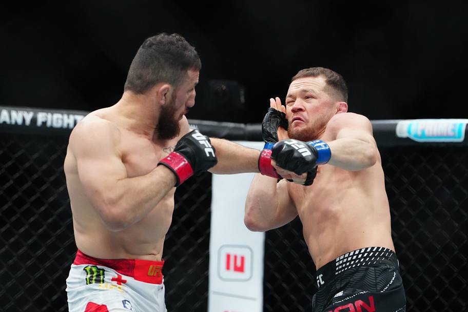 Merab Dvalishvili (red gloves) fights Petr Yan (blue gloves) during UFC 323 at T-Mobile Arena.