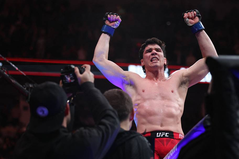 Mike Malott (blue gloves) reacts after defeating Gilbert Burns (red gloves) during UFC Fight Night at Canada Life Centre.