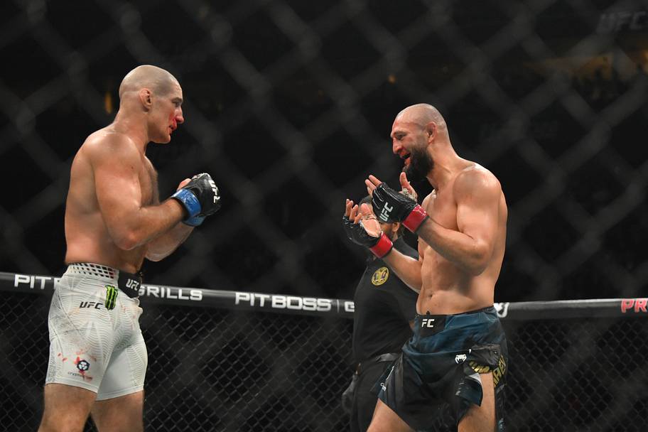 Khamzat Chimaev (red gloves) fights Sean Strickland (blue gloves) during UFC 328 at Prudential Center.