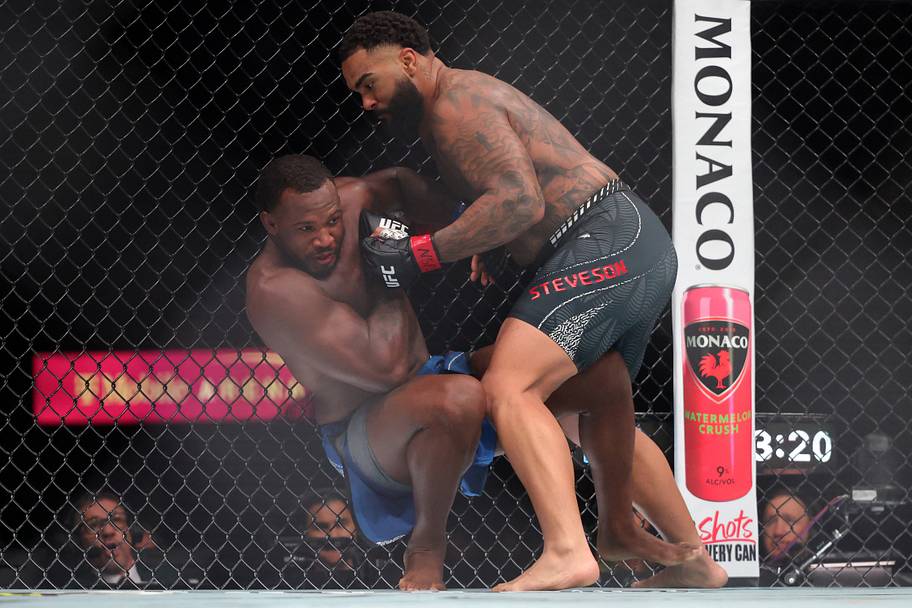 Gable Steveson (red gloves) fights Elisha Ellison (blue gloves) in a heavyweight bout during UFC 329 at T-Mobile Arena.