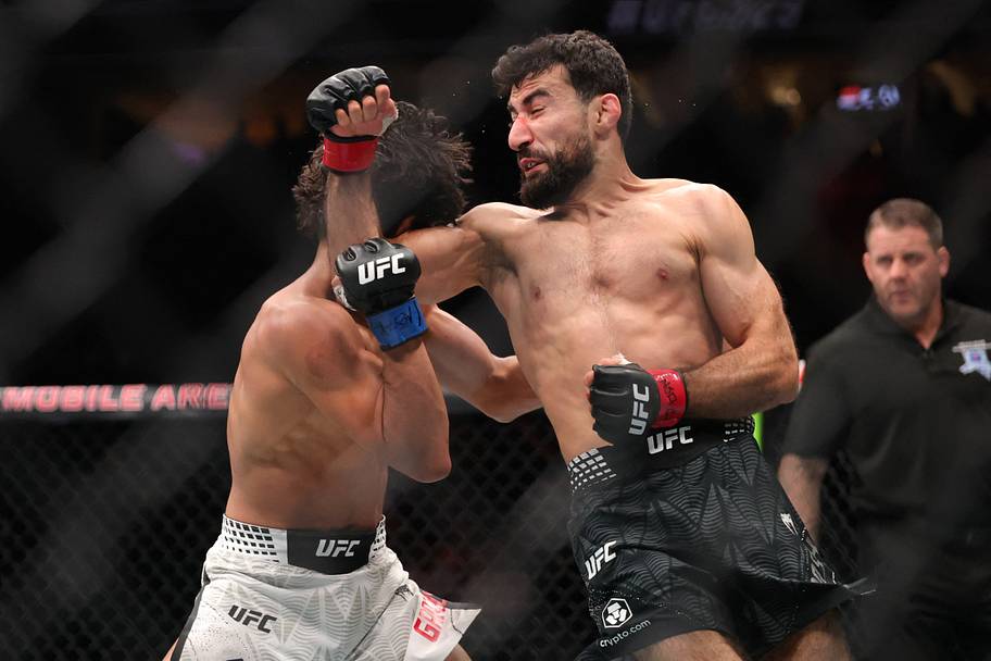 Farid Basharat (red gloves) fights John Garza (blue gloves) in a bantamweight bout during UFC 329 at T-Mobile Arena.