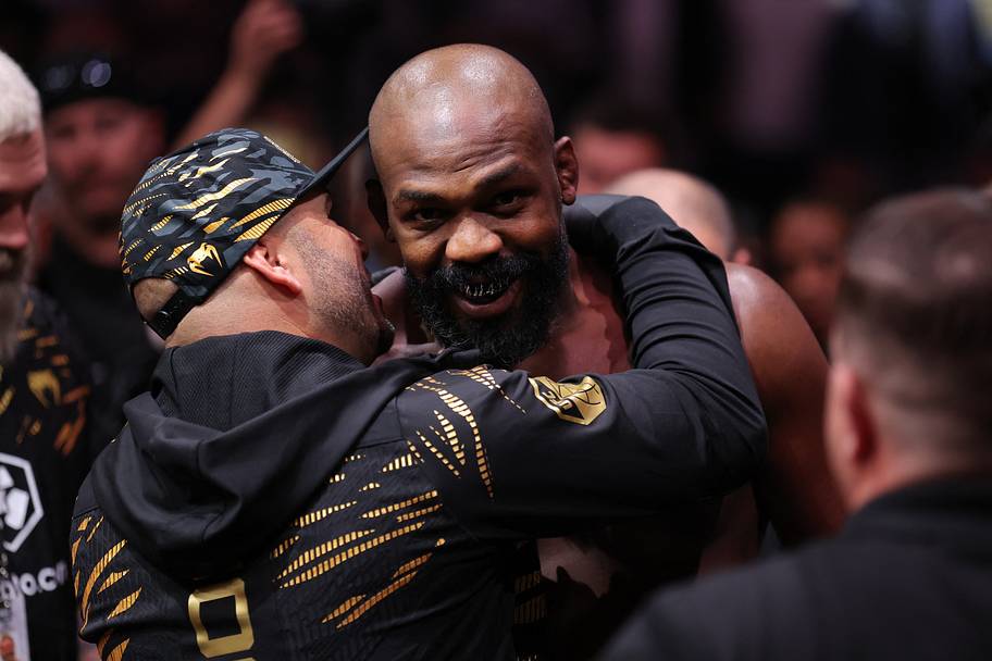 Jon Jones (red gloves) enters prior to fighting Stipe Miocoic (blue gloves) in the heavyweight bout during UFC 309 at Madiso