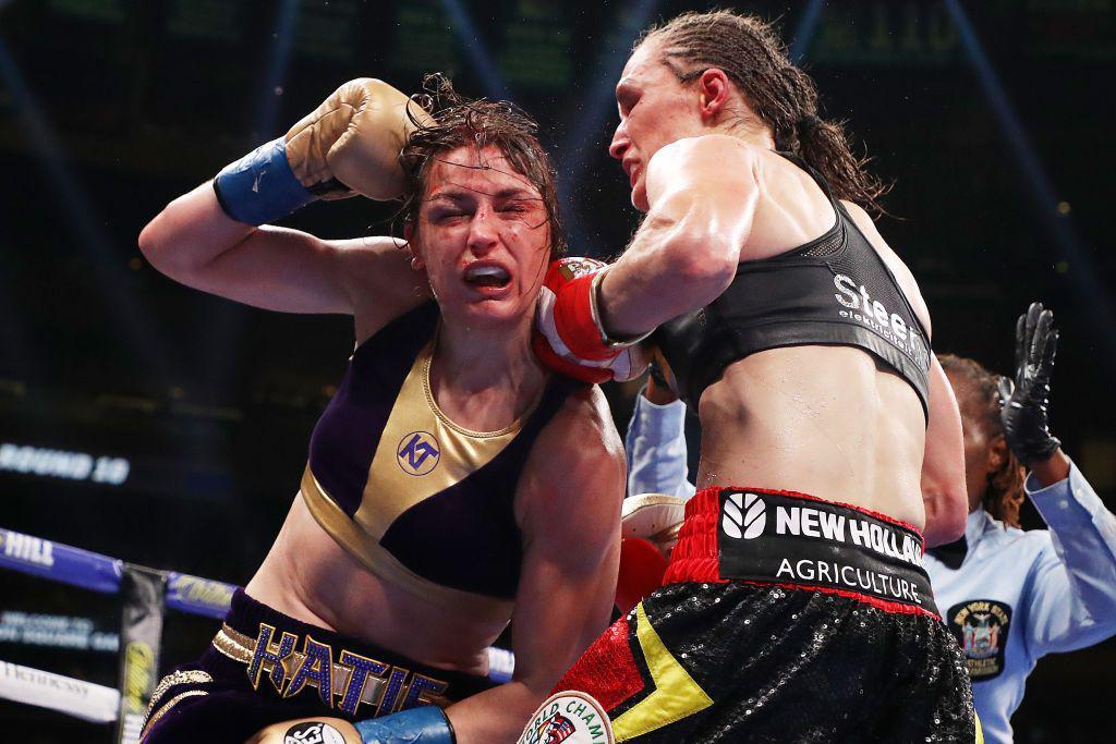 Katie Taylor falls forward from a punch from Delfine Persoon