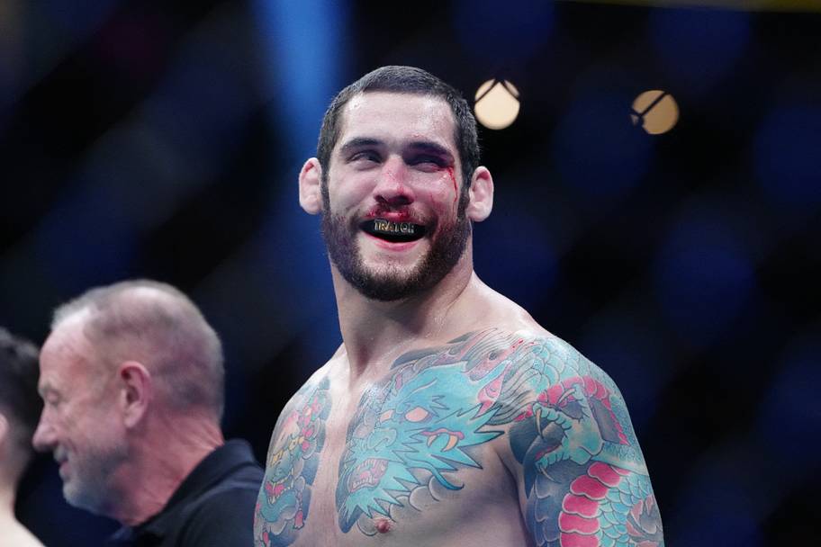 Rodolfo Bellato (blue gloves) reacts after defeating Luke Fernandez (red gloves) during UFC 326 at T-Mobile Arena.