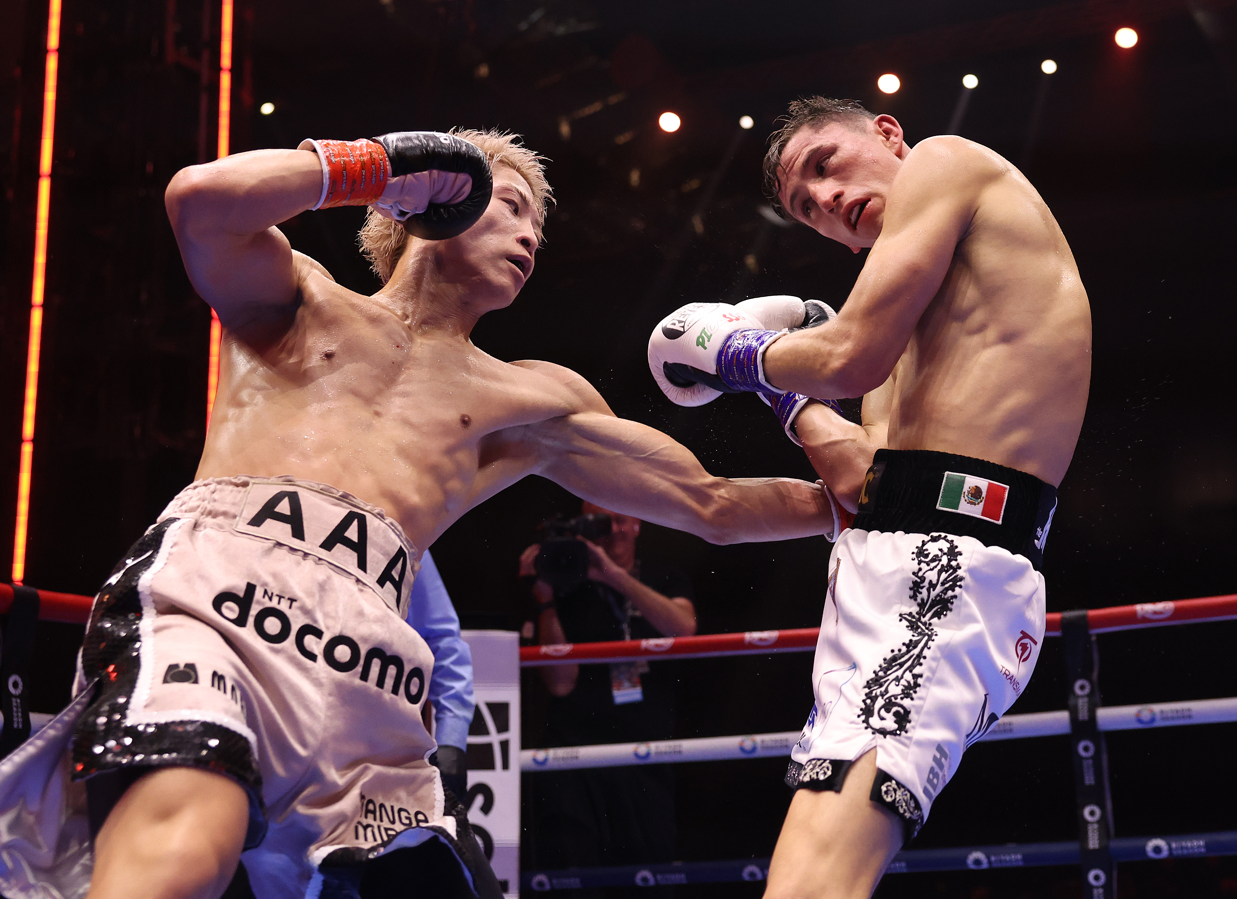 RIYADH, SAUDI ARABIA - DECEMBER 27: Naoya Inoue (pink shorts) vs David Picasso, Undisputed IBF, WBC, WBA and WBO World Super Bantamweight Title fight, during the Ring V: Night Of The Samurai fight night at Mohammed Abdo Arena on December 27, 2025 in Riyadh, Saudi Arabia. (Photo by Mark Robinson/Getty Images).