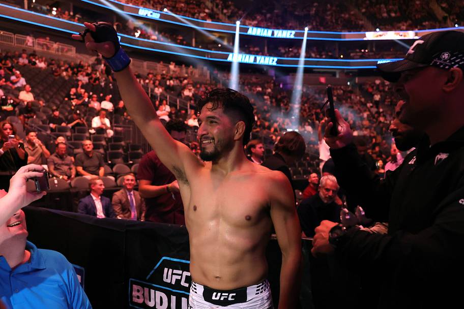 Adrian Yanez (blue gloves) reacts after a bantamweight bout during UFC 329 at T-Mobile Arena.