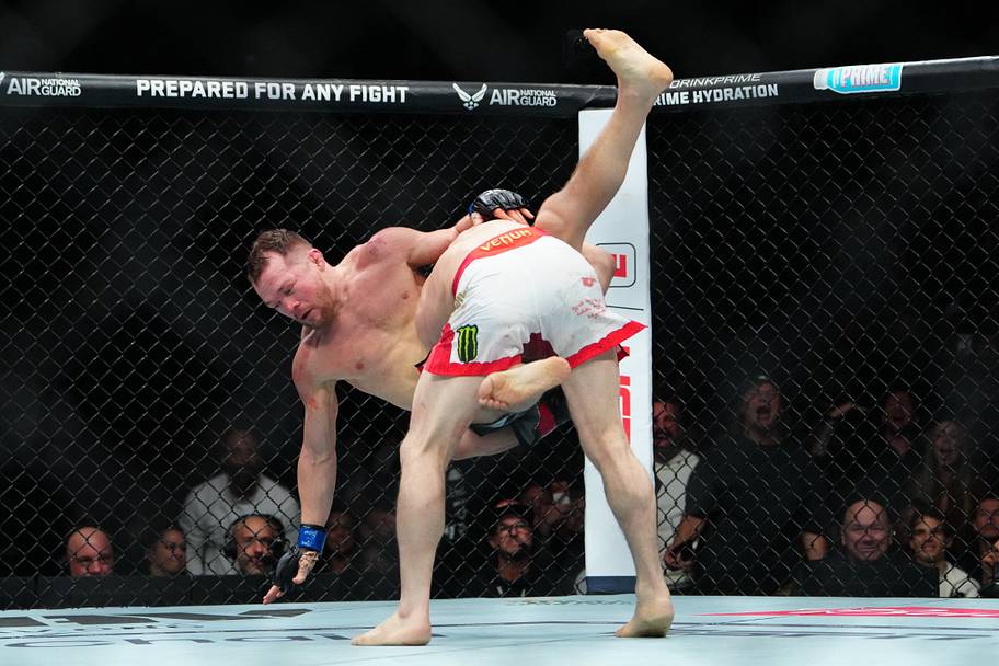 Merab Dvalishvili (red gloves) fights Petr Yan (blue gloves) during UFC 323 at T-Mobile Arena.