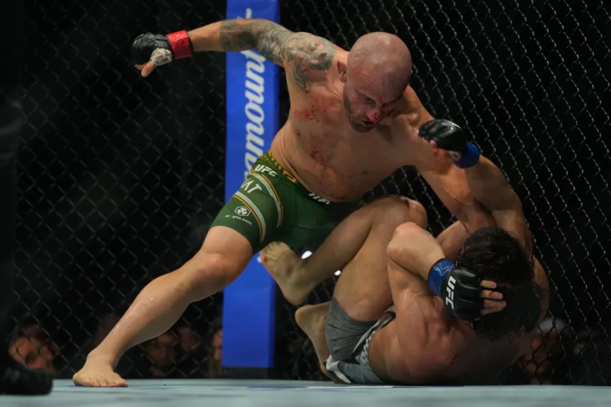 An image collage containing 1 images, Image 1 shows Alexander Volkanovski (left) pins down Mosvar Evloev during his victory in their featherweight title bout on Oct. 24, 2026 in Abu Dhabi, United Arab Emirates