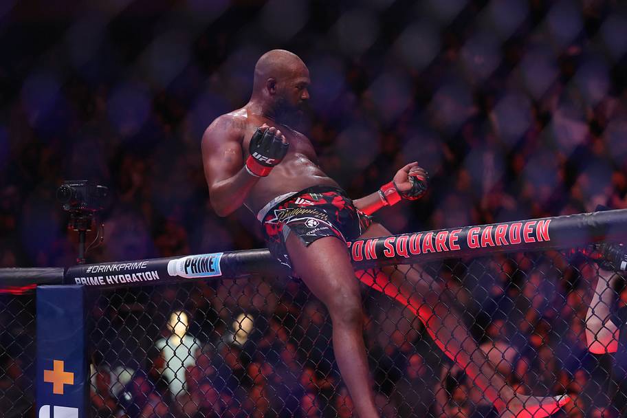 Jon Jones (red gloves) celebrates defeating Stipe Miocoic (blue gloves) in the heavyweight bout during UFC 309 at Madison Squ