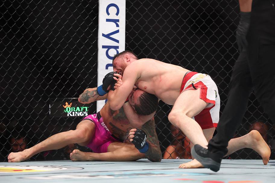 Merab Dvalishvili (red gloves) fights Sean O'Malley (blue gloves) in a bantamweight title fight during UFC 316 at Prudential