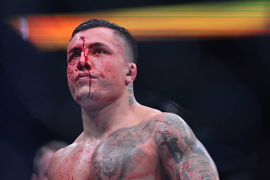 Francisco Prado (blue gloves) reacts during the fight against Charles Radtke (red gloves) during UFC 327 at Kaseya Center.