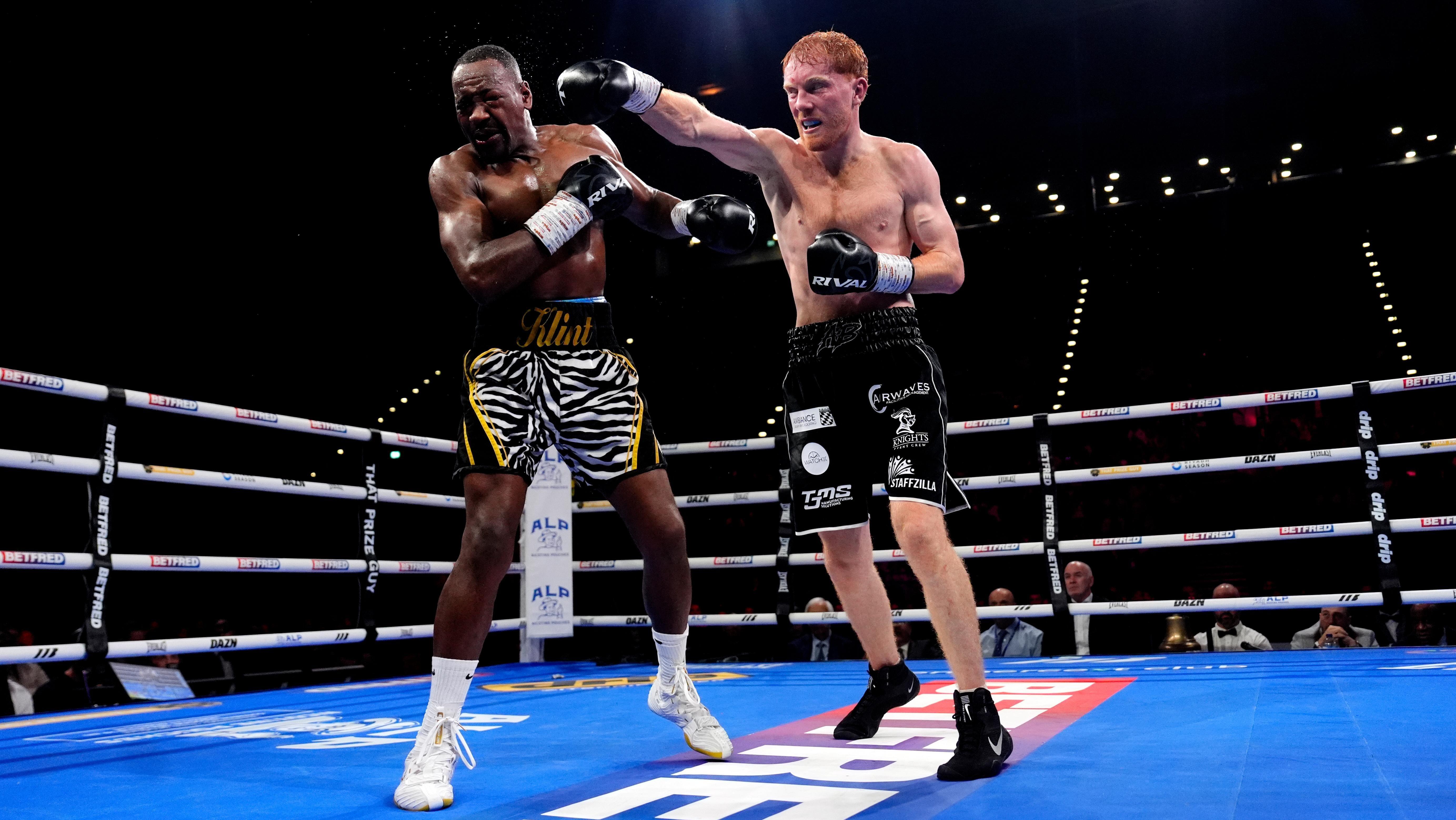 A picture from the Bowen-Baptiste fight. Baptiste is on the left, wearing black shorts with a black and white tiger-stripe pattern with yellow edging. Bowen is on the right, with black shorts and white sponsorship logos.