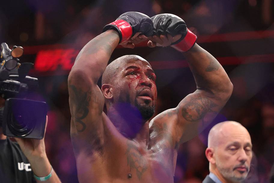 King Green (red gloves) celebrates after defeating Terrance McKinney (blue gloves) in a lightweight bout during UFC 329 at T-