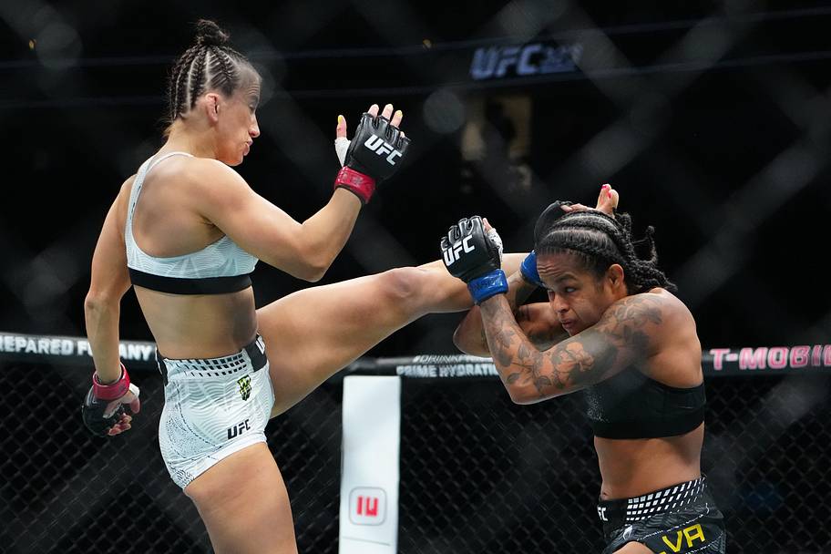 Maycee Barber (red gloves) fights Karine Silva (blue gloves) during UFC 323 at T-Mobile Arena.