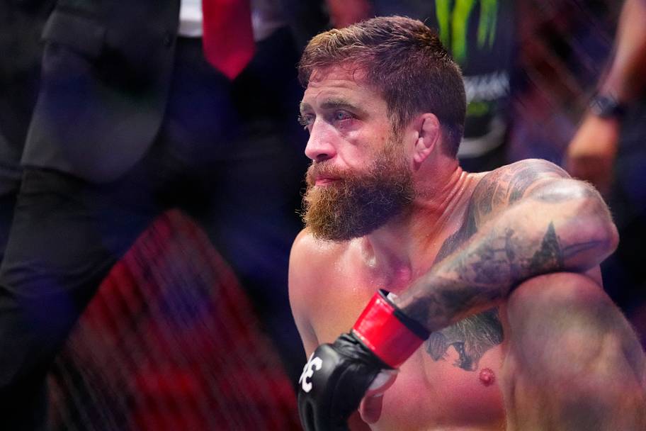Gerald Meerschaert (red gloves) reacts after fighting Joe Pyfer (blue gloves) during UFC 287 at Miami-Dade Arena.