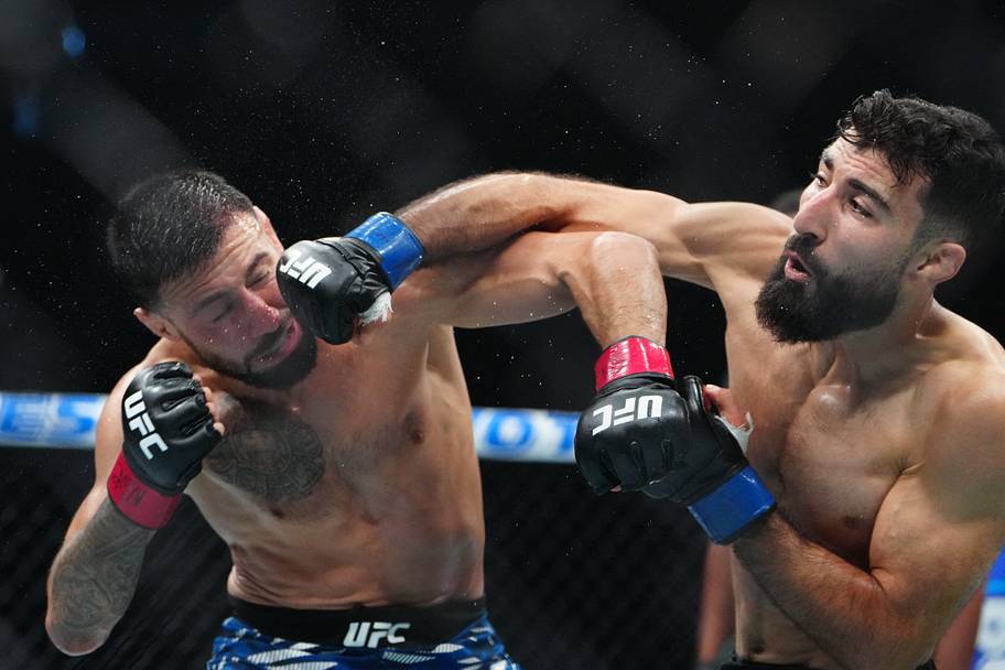 Chris Gutierrez (red gloves) fights Farid Basharat (blue gloves) during UFC 320 at T-Mobile Arena.