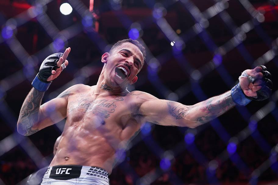 Carlos Prates (blue gloves) reacts after defeating Leon Edwards (not pictured) in the welterweight bout during UFC 322 at Mad