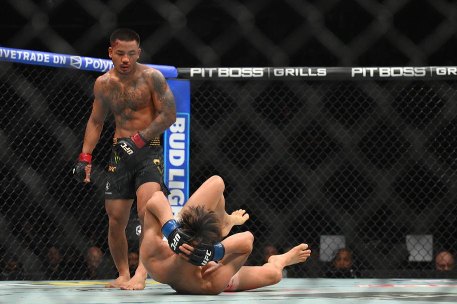 Joshua Van (red gloves) fights Tatsuro Taira (blue gloves) during UFC 328 at Prudential Center.