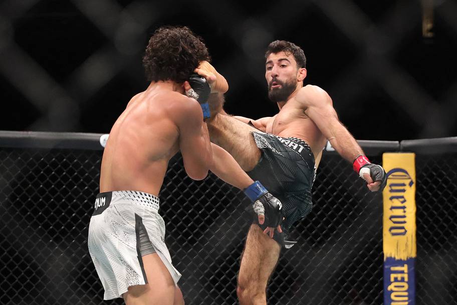 Farid Basharat (red gloves) fights John Garza (blue gloves) in a bantamweight bout during UFC 329 at T-Mobile Arena.