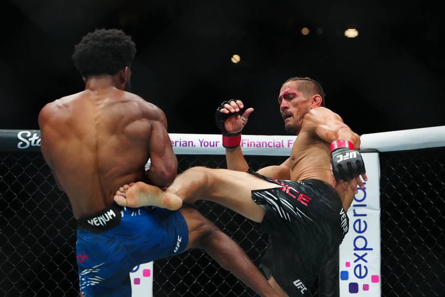 Niko Price (red gloves) fights Jacobe Smith (blue gloves) during UFC 317 at T-Mobile Arena.