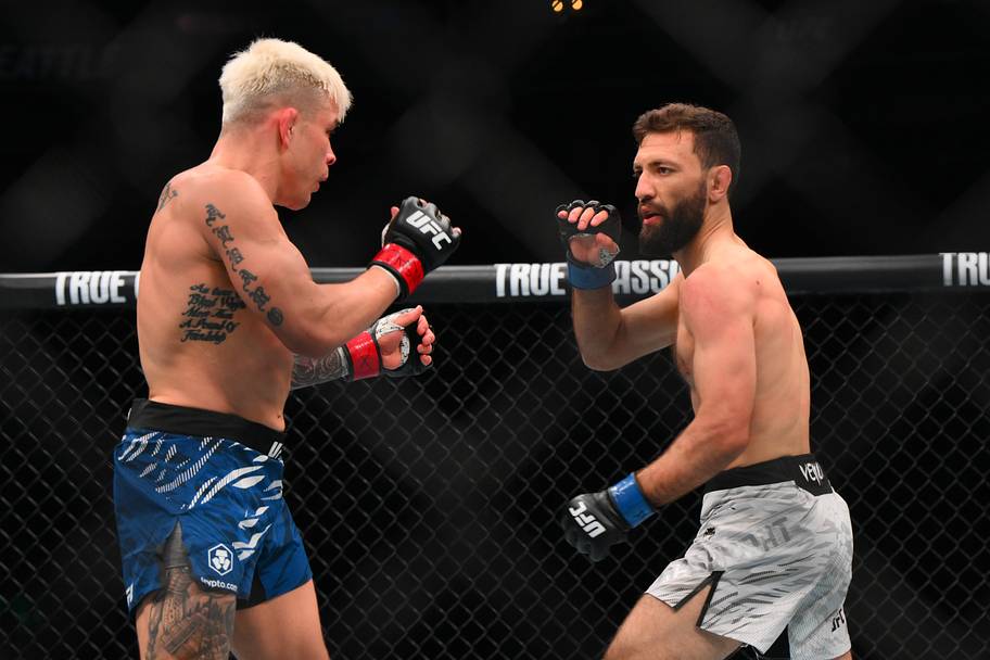 Ricky Simon (red gloves) fights Javid Basharat (blue gloves) in the bantamweight bout during UFC Fight Night at Climate Pledg