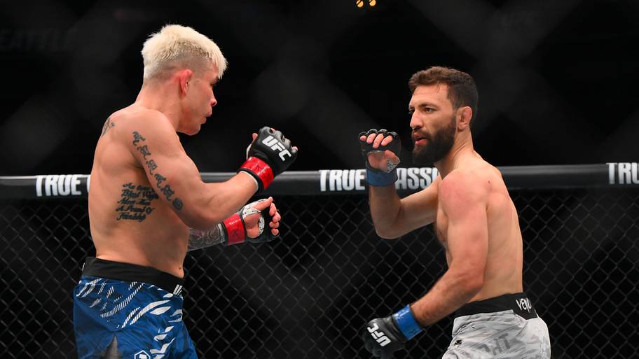Ricky Simon (red gloves) fights Javid Basharat (blue gloves) in the bantamweight bout during UFC Fight Night at Climate Pledg