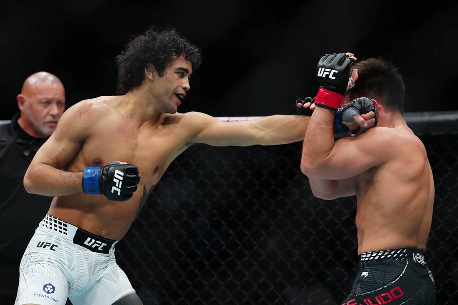 Henry Cejudo (red gloves) fights Payton Talbott (blue gloves) during UFC 323 at T-Mobile Arena.