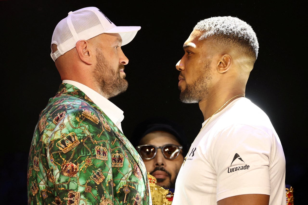 Tyson Fury (left) faces off with Anthony Joshua at their launch press conference (Reuters)