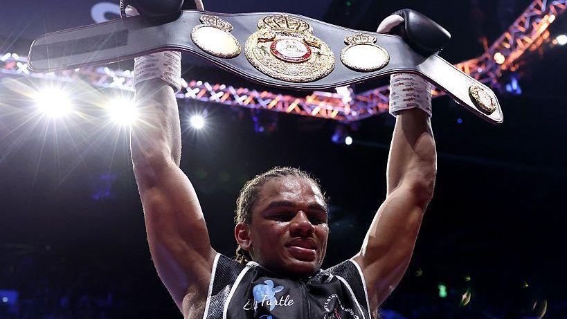 erome Warburton celebrates victory with his title belt after defeating Nathan Heaney (not pictured)