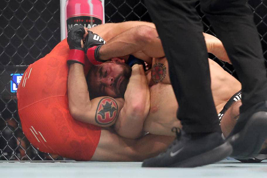 Benoit Saint-Denis (red gloves) fights Paddy Pimblett (blue gloves) in a lightweight bout during UFC 329 at T-Mobile Arena.