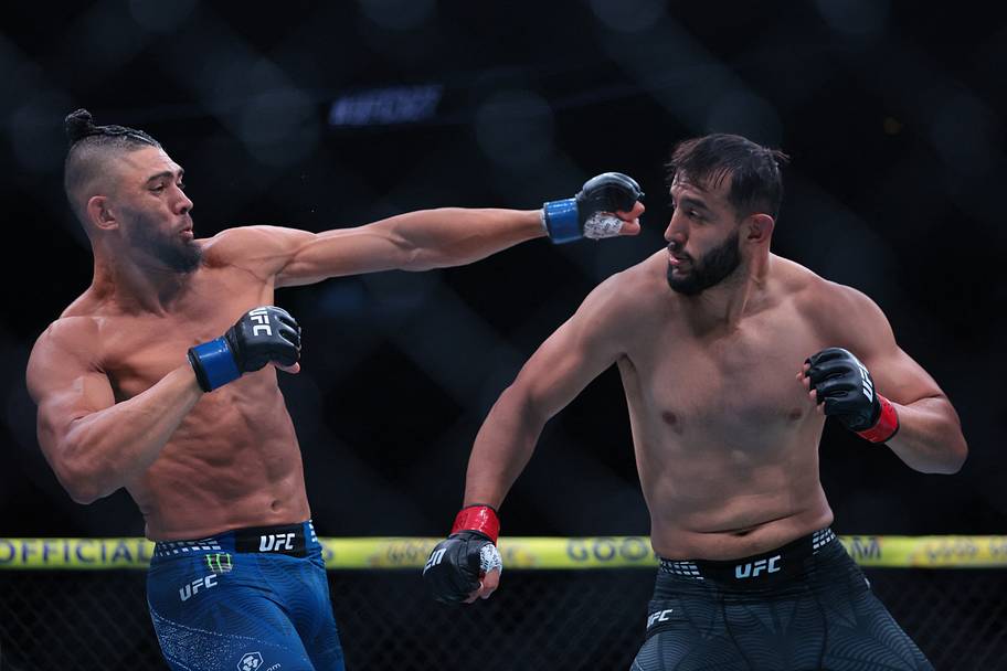 Dominick Reyes (red gloves) fights Johnny Walker (blue gloves) during UFC 327 at Kaseya Center.