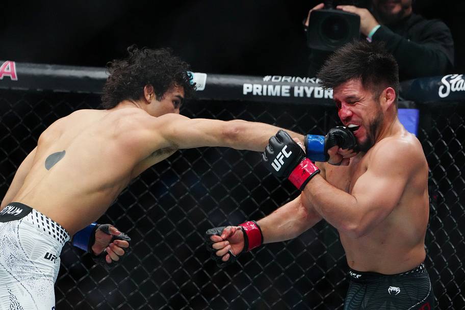 Henry Cejudo (red gloves) fights Payton Talbott (blue gloves) during UFC 323 at T-Mobile Arena.